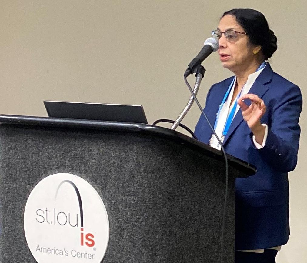 Dr. Vimala Nair speaking at a podium during the annual SSSA conference.