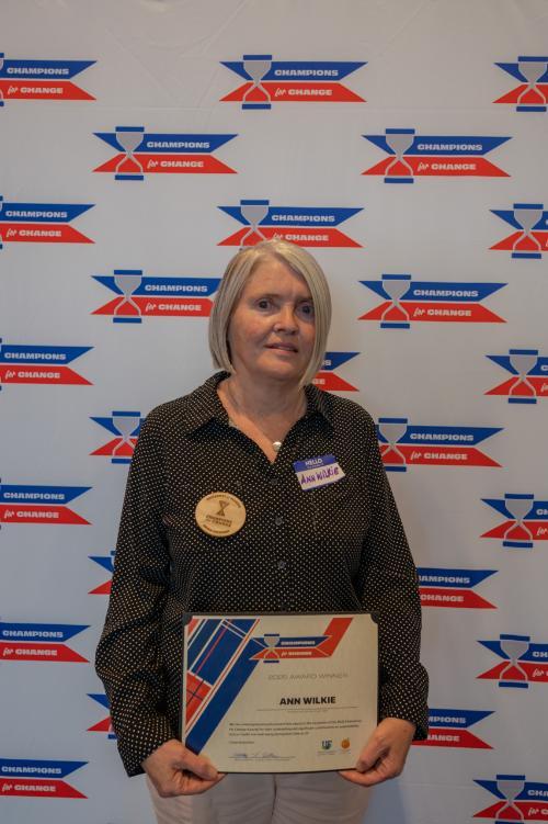 Ann Wilkie holding Champions for Change Award