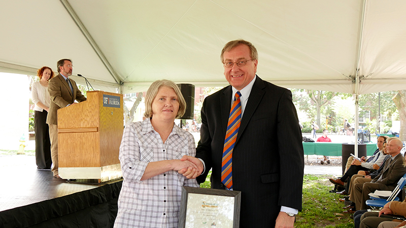 Kent Fuchs congratulating Ann Wilkie during award ceremony