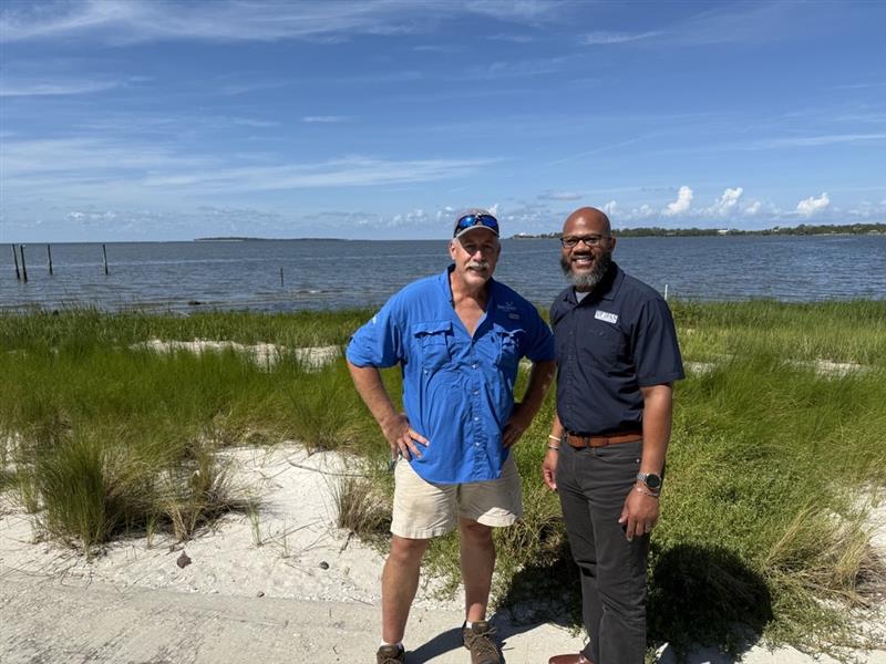 Dr. Mark Clark stands to the left of Dr. Andra Johnson, posing for a picture after they discussed the Living Shoreline project on Cedar Key, FL, and ways to help those at risk for hurricane damage.