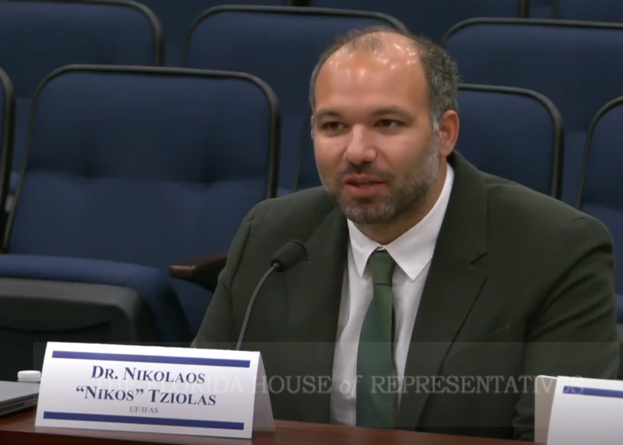 Dr. Nikos Tziolas sits to testify at a Florida House hearing on AI chatbot use in agriculture.