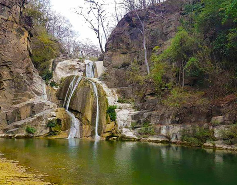 A view of a small waterfall emptying into a stream in Ecuador