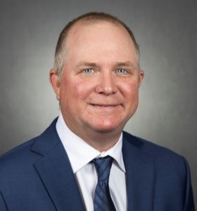 A headshot of Paul White