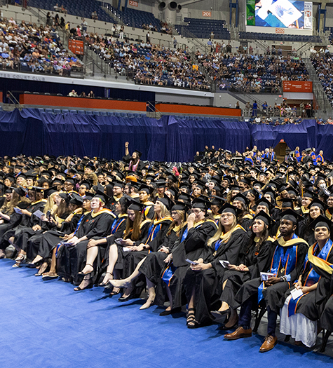 University of Florida graduates sitting in the O'Connell Center at commencement