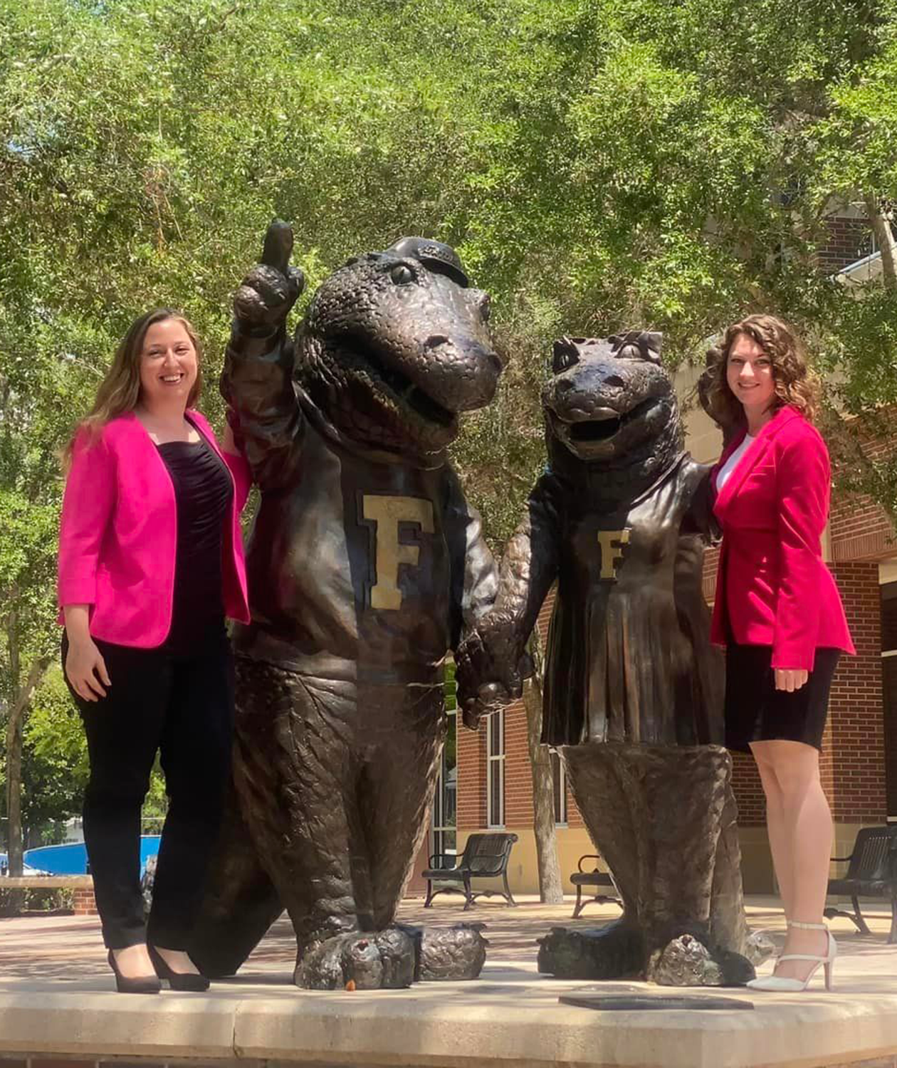 Jessica and Monica standing by the UF Alumni Center gator statues