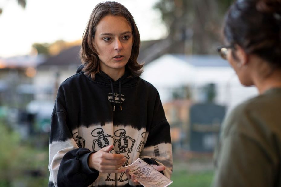 Katya Kasprzak holds a brochure while tabling at the UF/IFAS Plant Sciences Fall Festival.
